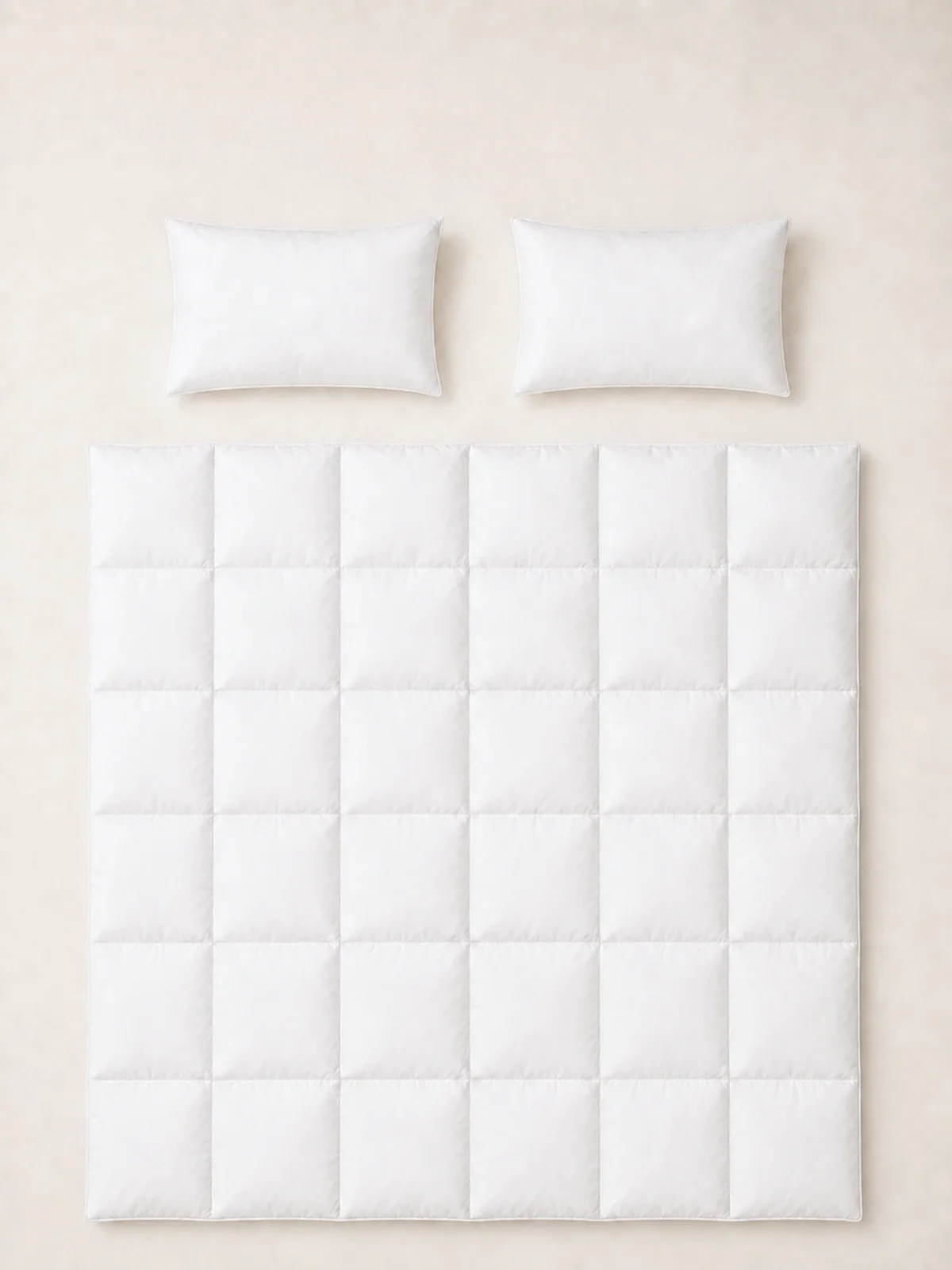 One Duck Down Duvet and two Pure Down Pillows arranged together.
